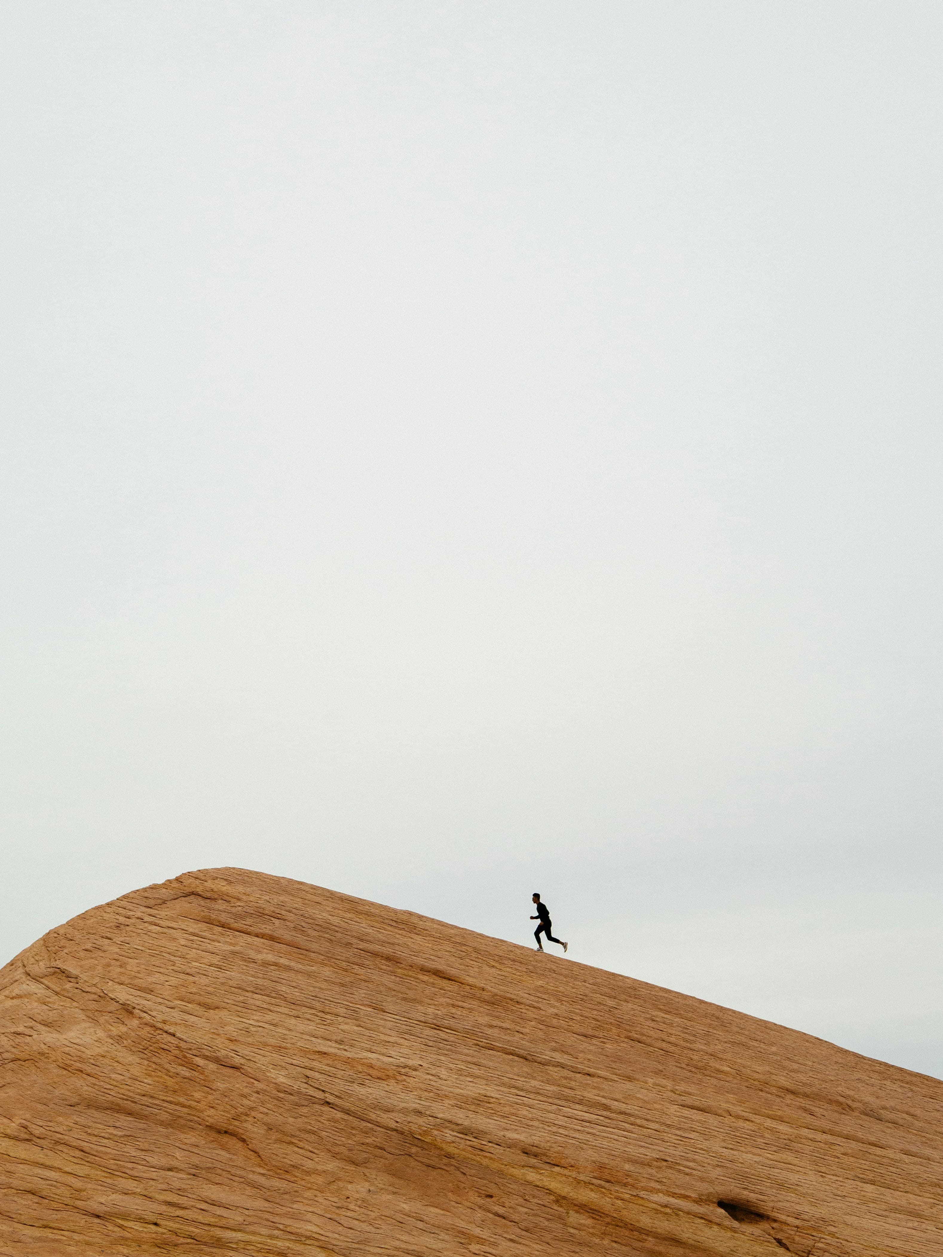 Ultra-runner on rust-colored desert ridge